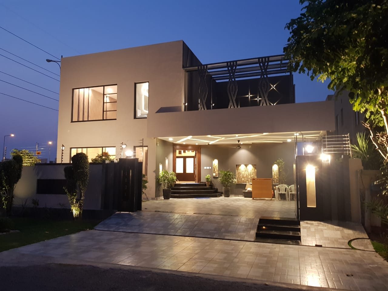 Illuminated turnkey house at night by Bunyad Allied